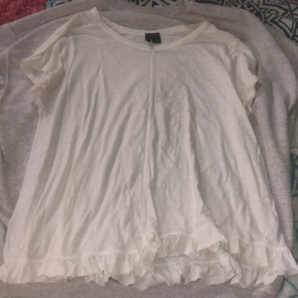 white flowy shirt with ruffles on bottom